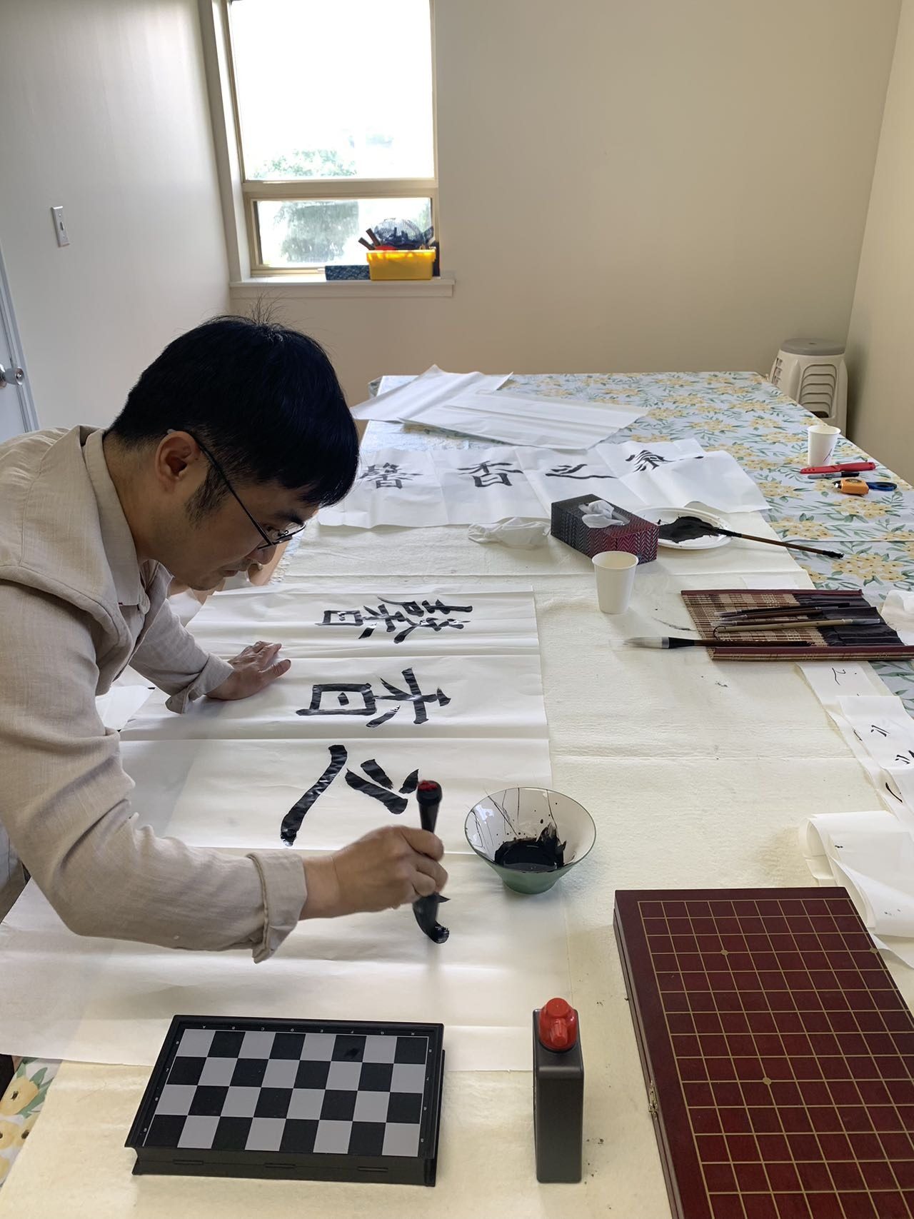 Duane writing Chinese calligraphy with a brush